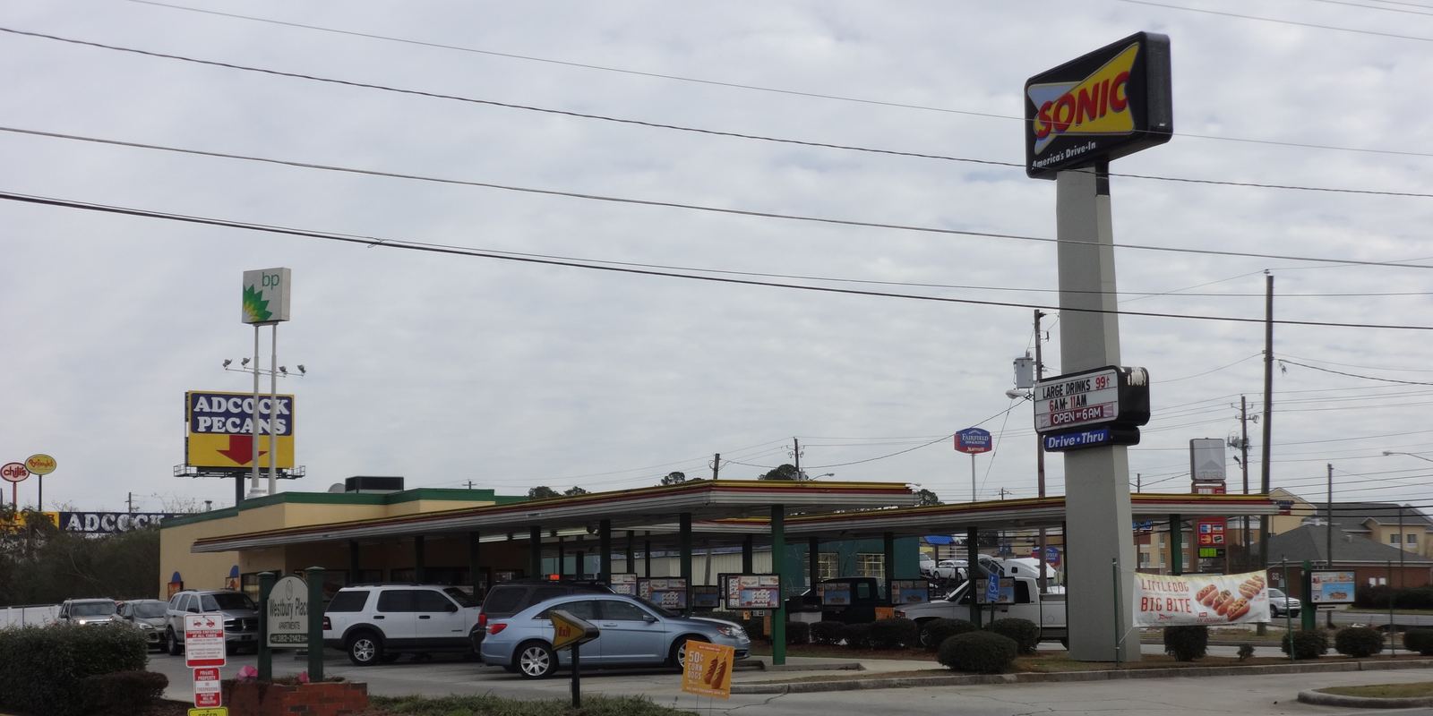 A Sonic drive-in with covered parking stalls and menu boards