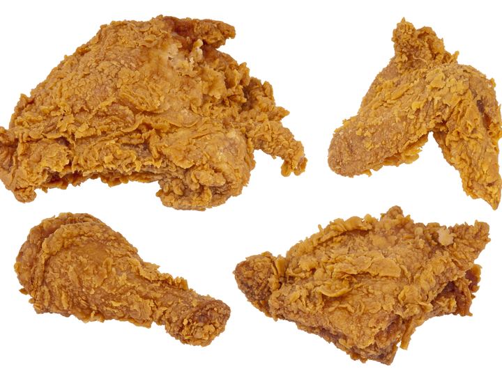 A plate of golden fried chicken pieces with sides